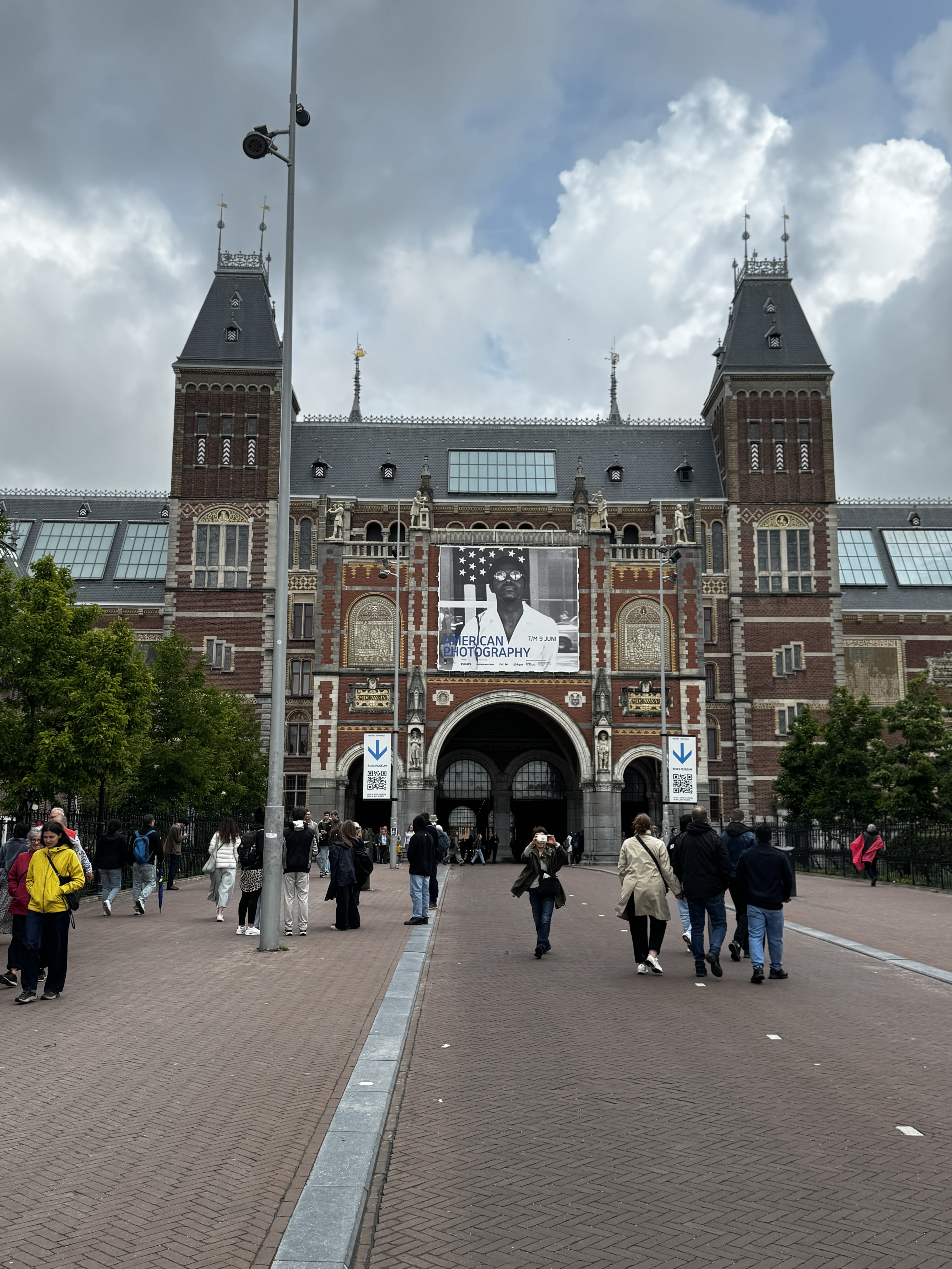 Rijksmuseum exterior in Amsterdam with visitors approaching the entrance